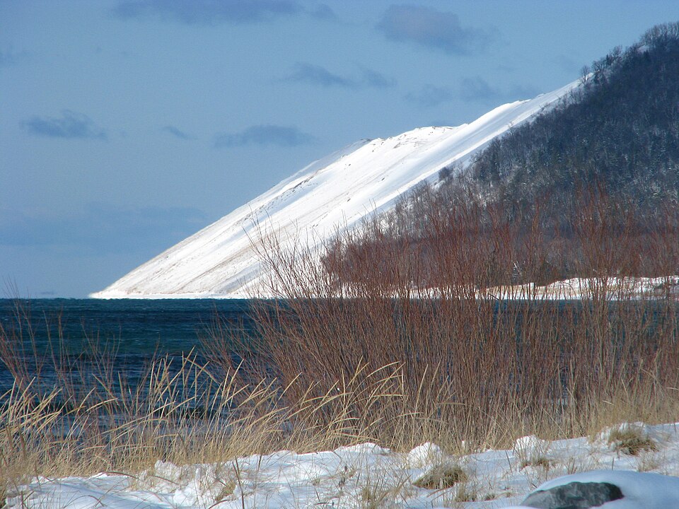 Snow-covered pine bluffs overlooking frozen shoreline in Benzie County and Crystal Mountain country